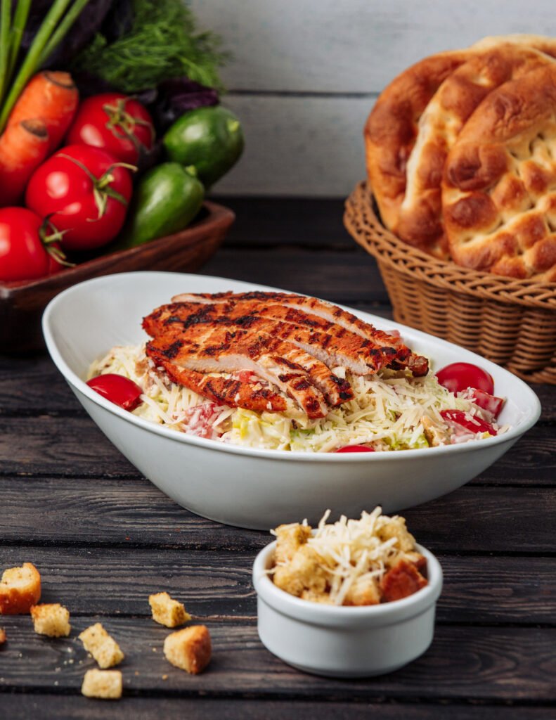 chicken caesar with grated cheese on the table